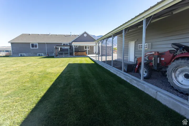 View of green lawn featuring a mountain view and a sunroom