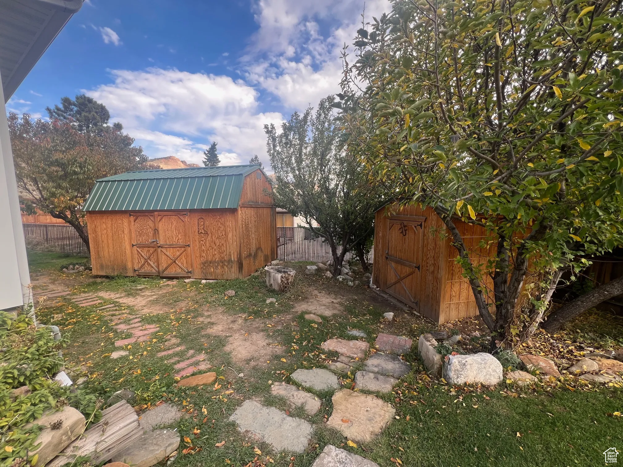 View of yard featuring 2 storage sheds