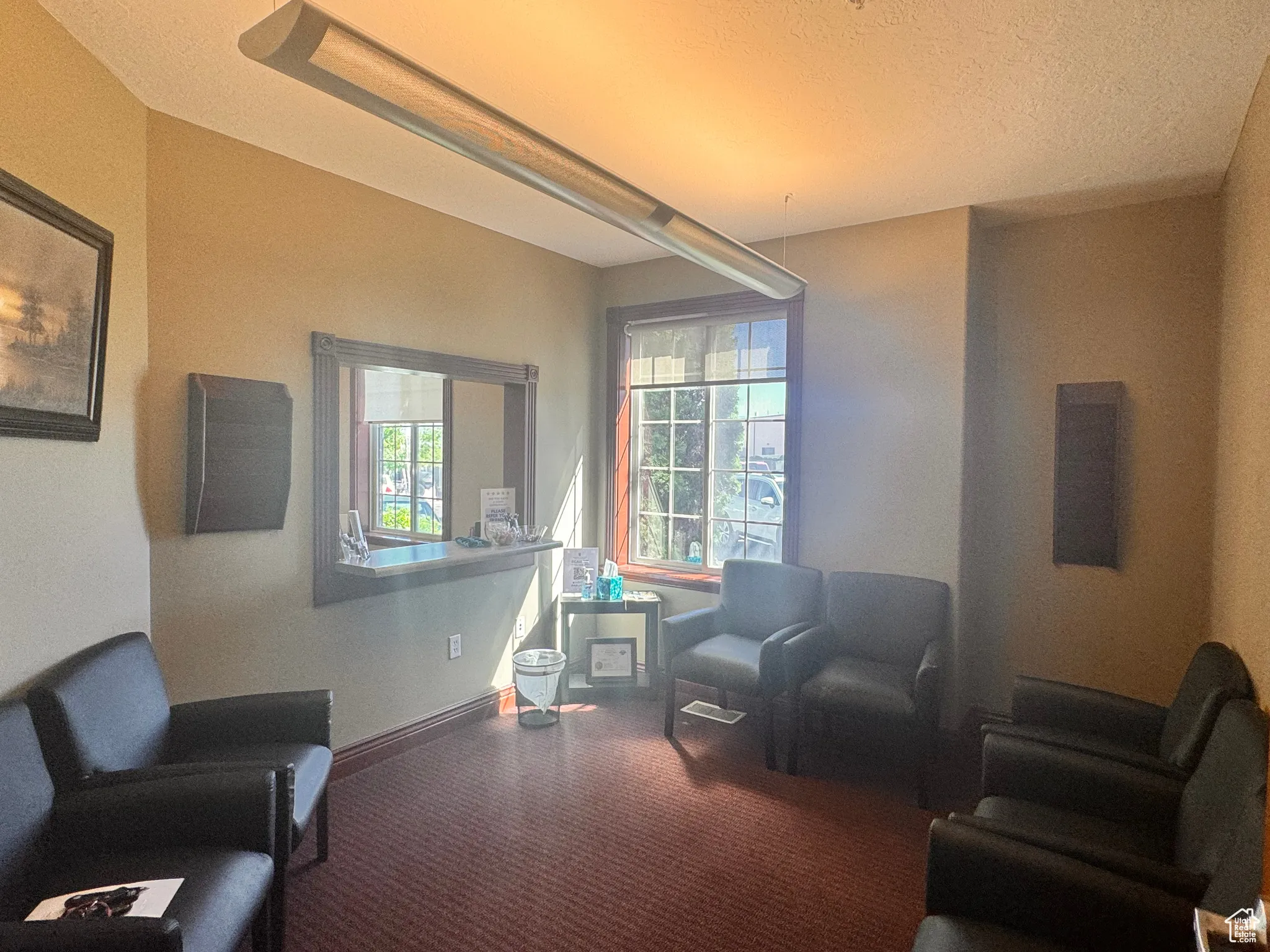 Sitting room with a textured ceiling and carpet floors