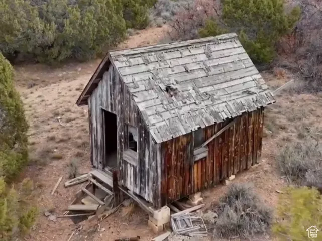 View of outbuilding with a wooded view and a mountain view