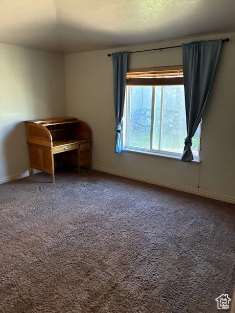 Unfurnished room with carpet flooring and baseboards