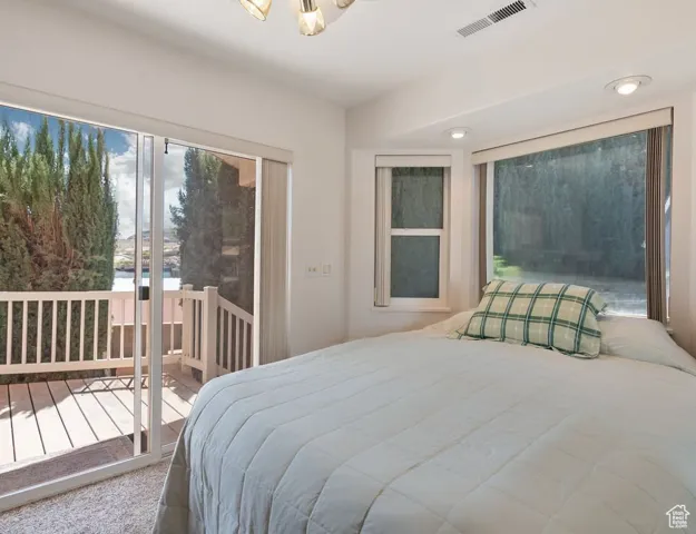 Carpeted bedroom featuring access to outside