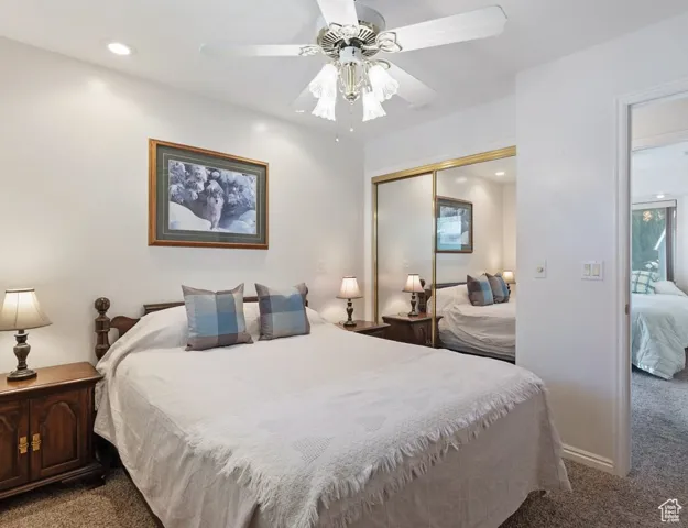 Bedroom featuring dark carpet, recessed lighting, ceiling fan, and a closet