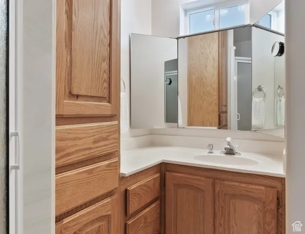 Bathroom featuring vanity and a stall shower
