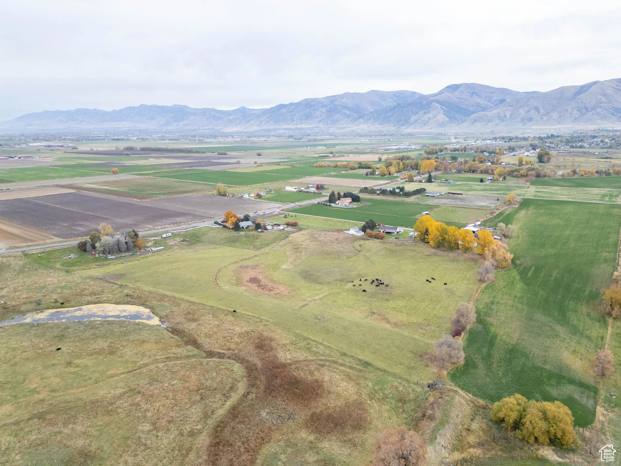 Aerial overview of property's location with a mountain backdrop and rural landscape