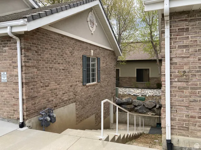 View of property exterior with brick siding