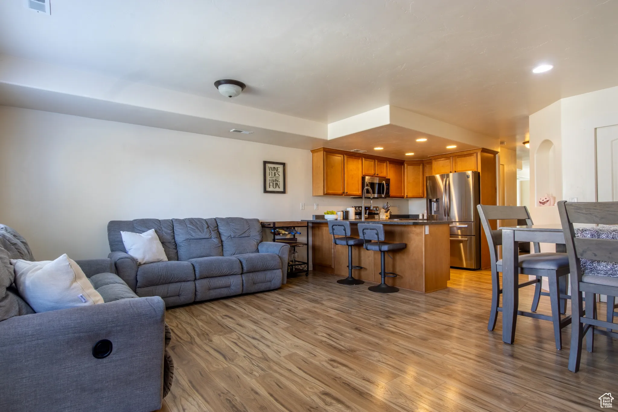 Living room featuring recessed lighting, light wood finished floors, and arched walkways