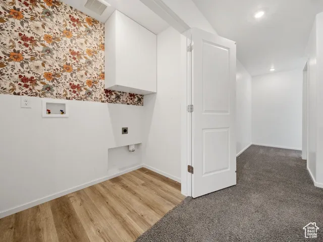 Washroom featuring hookup for an electric dryer, hookup for a washing machine, recessed lighting, wood finished floors, and carpet