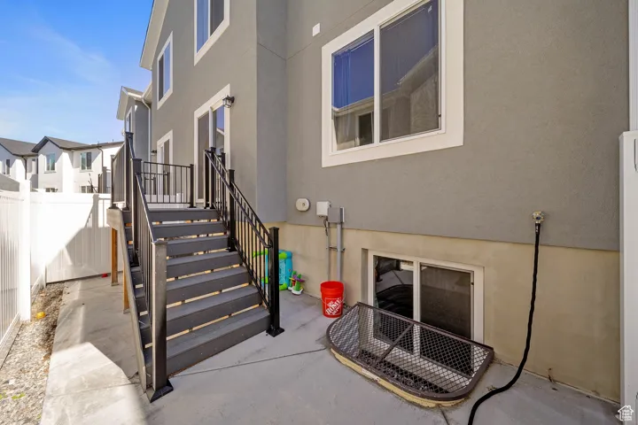 View of exterior entry featuring stucco siding and a residential view