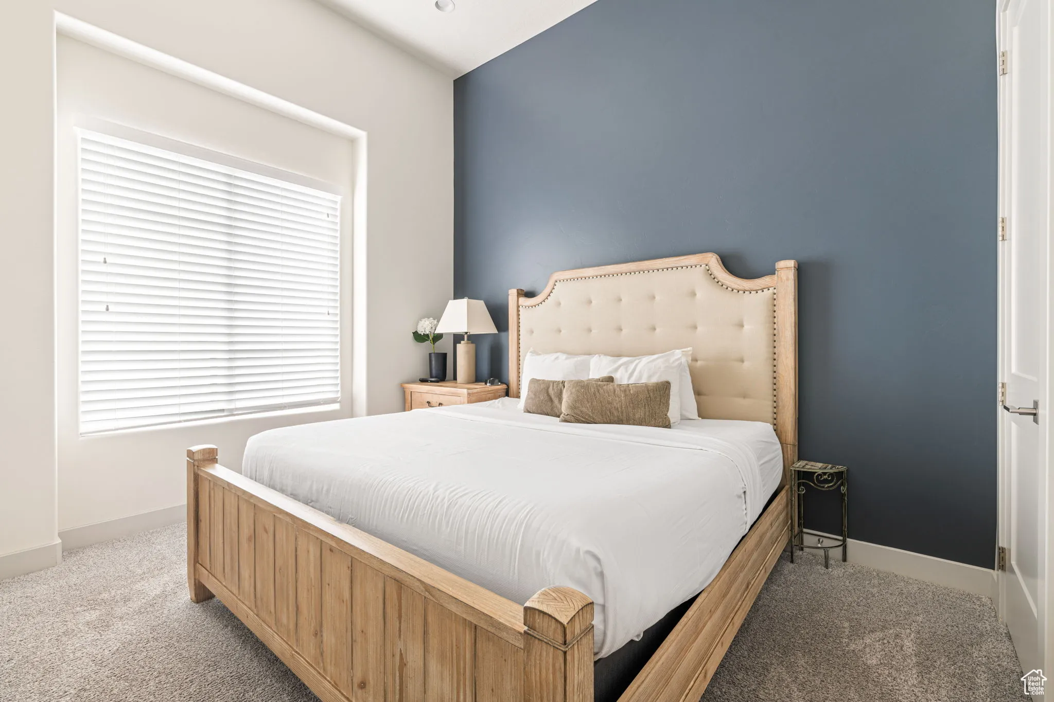 Carpeted bedroom featuring baseboards