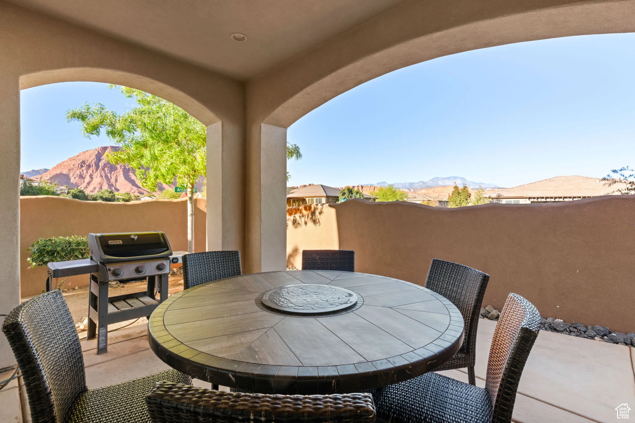 View of patio with a mountain view, outdoor dining area, and grilling area