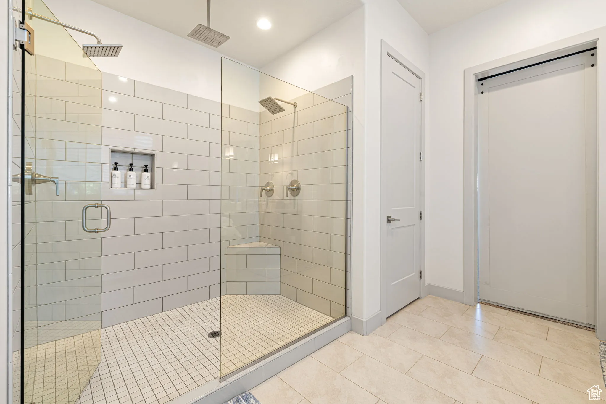 Full bathroom featuring a shower stall, light tile patterned floors, and recessed lighting