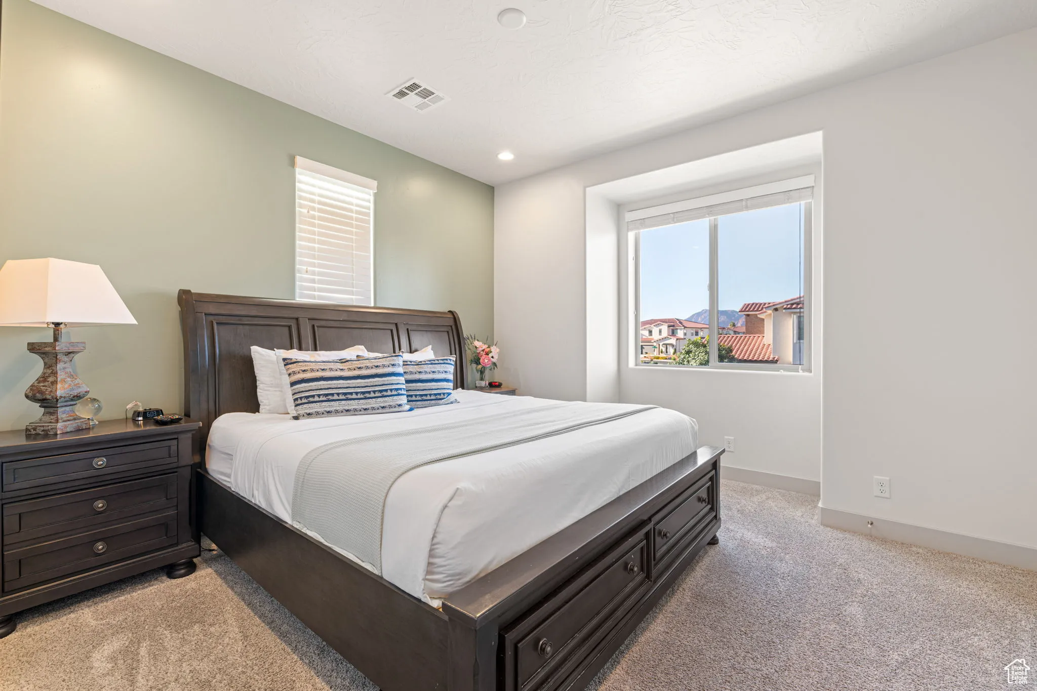 Bedroom with light colored carpet and recessed lighting