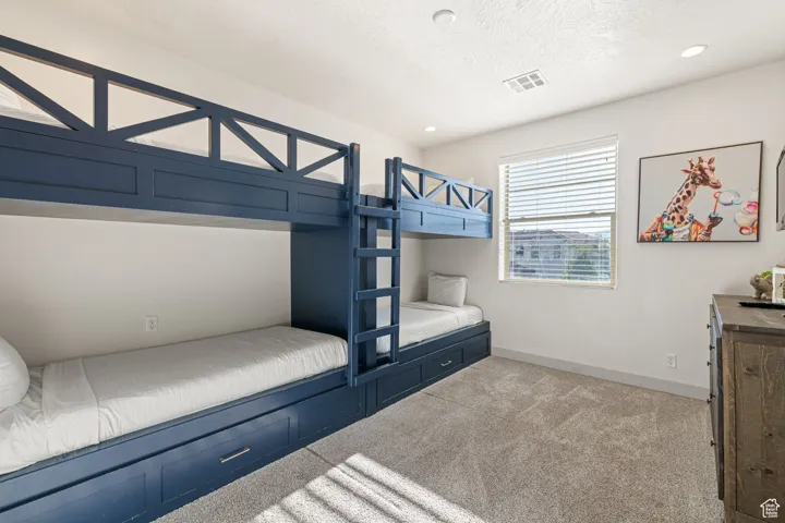 Unfurnished bedroom with light colored carpet, recessed lighting, and a textured ceiling