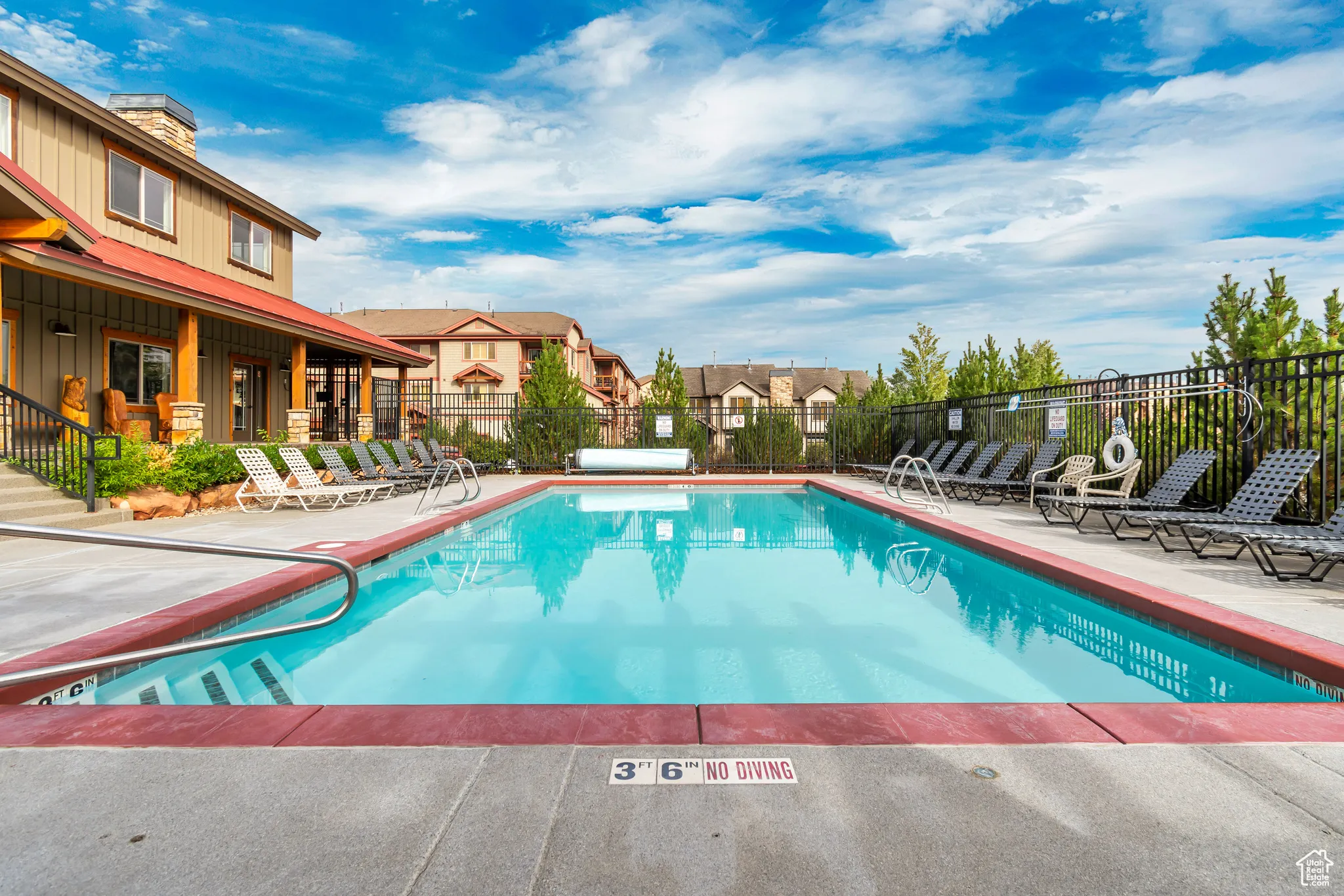 Community pool featuring a patio and a residential view