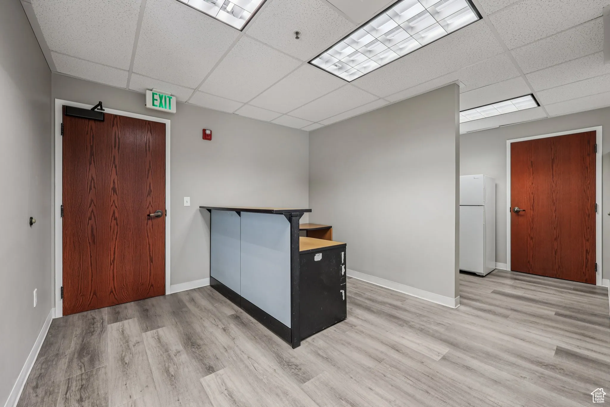Unfurnished office featuring a drop ceiling