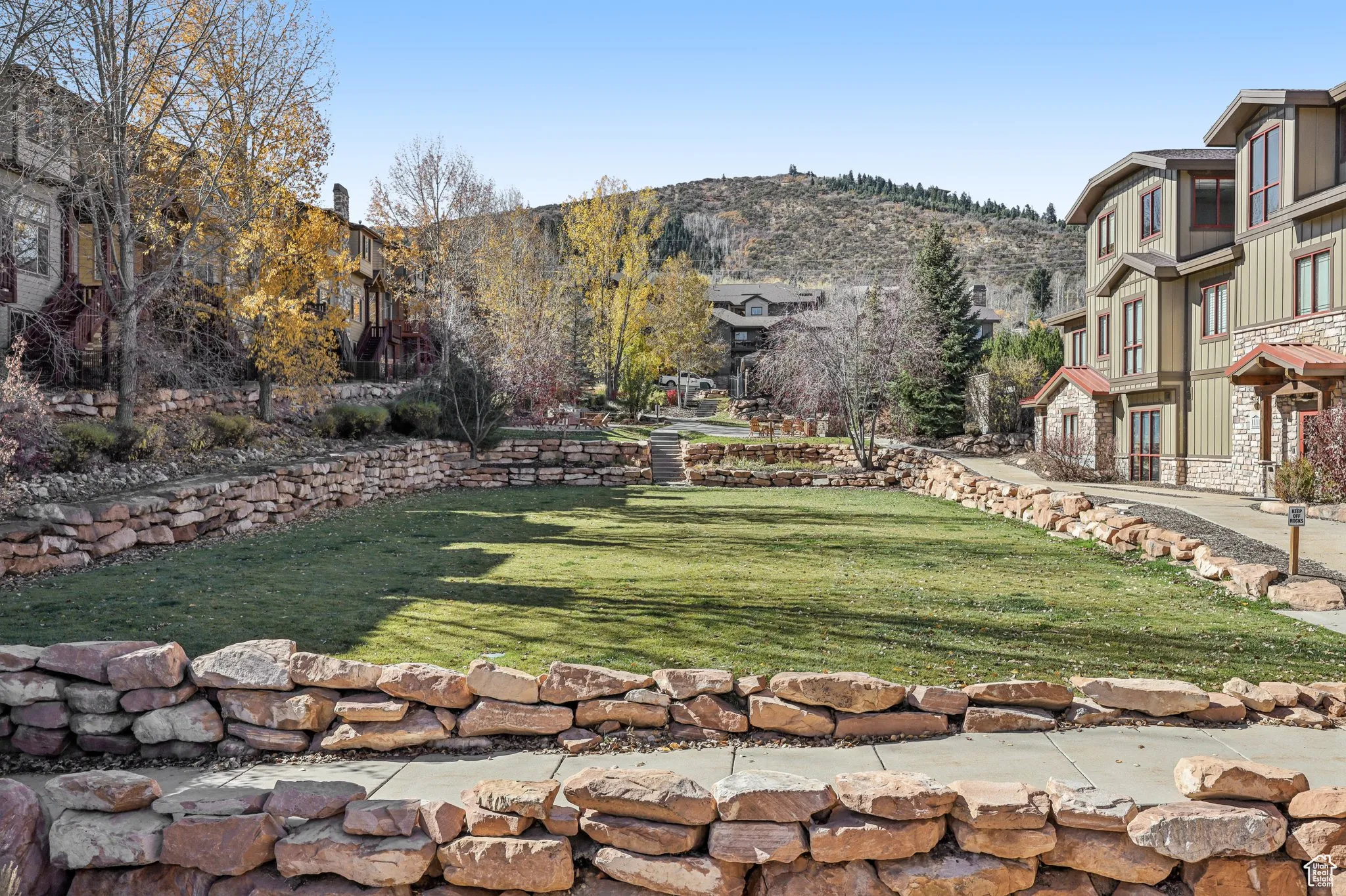 View of community featuring a lawn, a mountain view, and a residential view