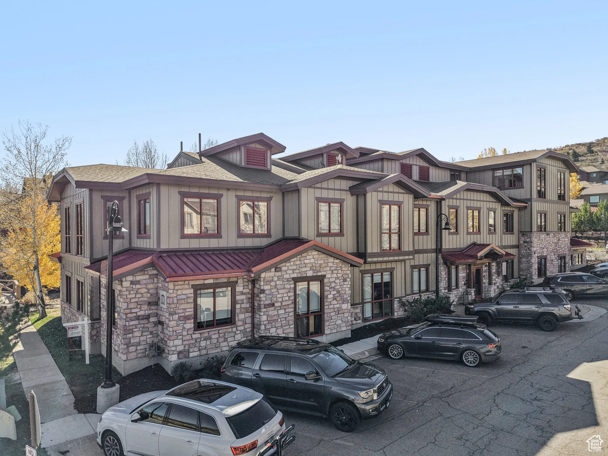 View of front of property featuring stone siding, a metal roof, a standing seam roof, and board and batten siding