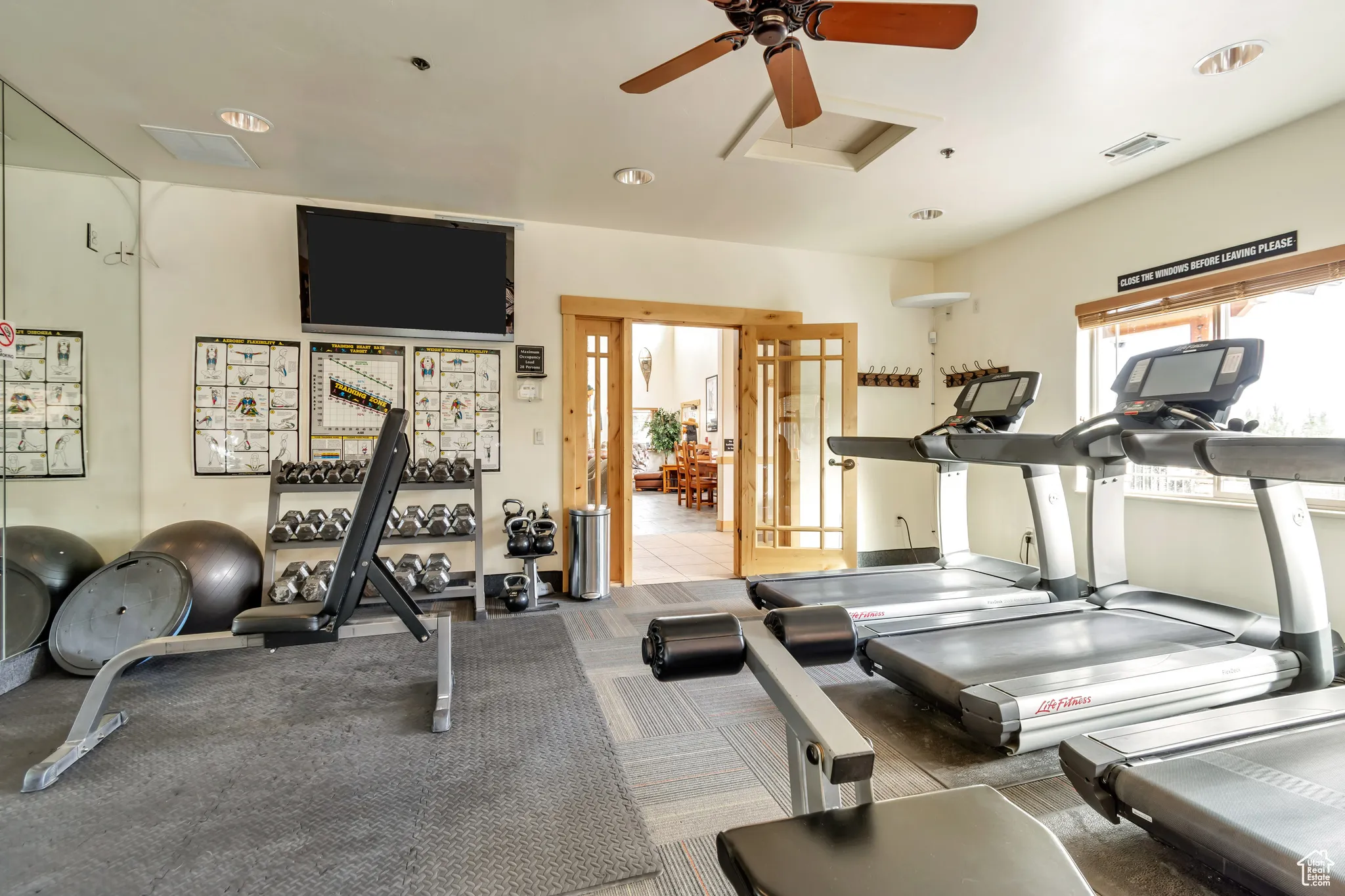 Gym featuring ceiling fan and recessed lighting