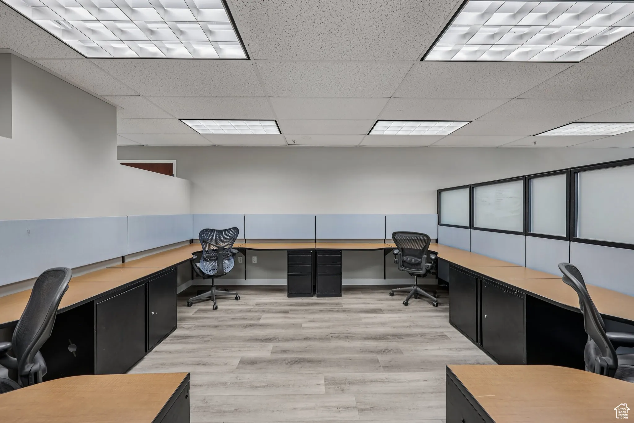 Office area featuring built in study area and a drop ceiling