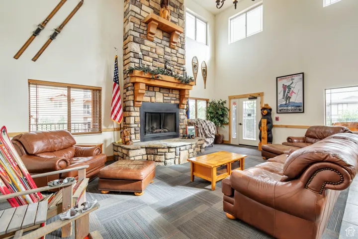 Living room with a stone fireplace and a towering ceiling