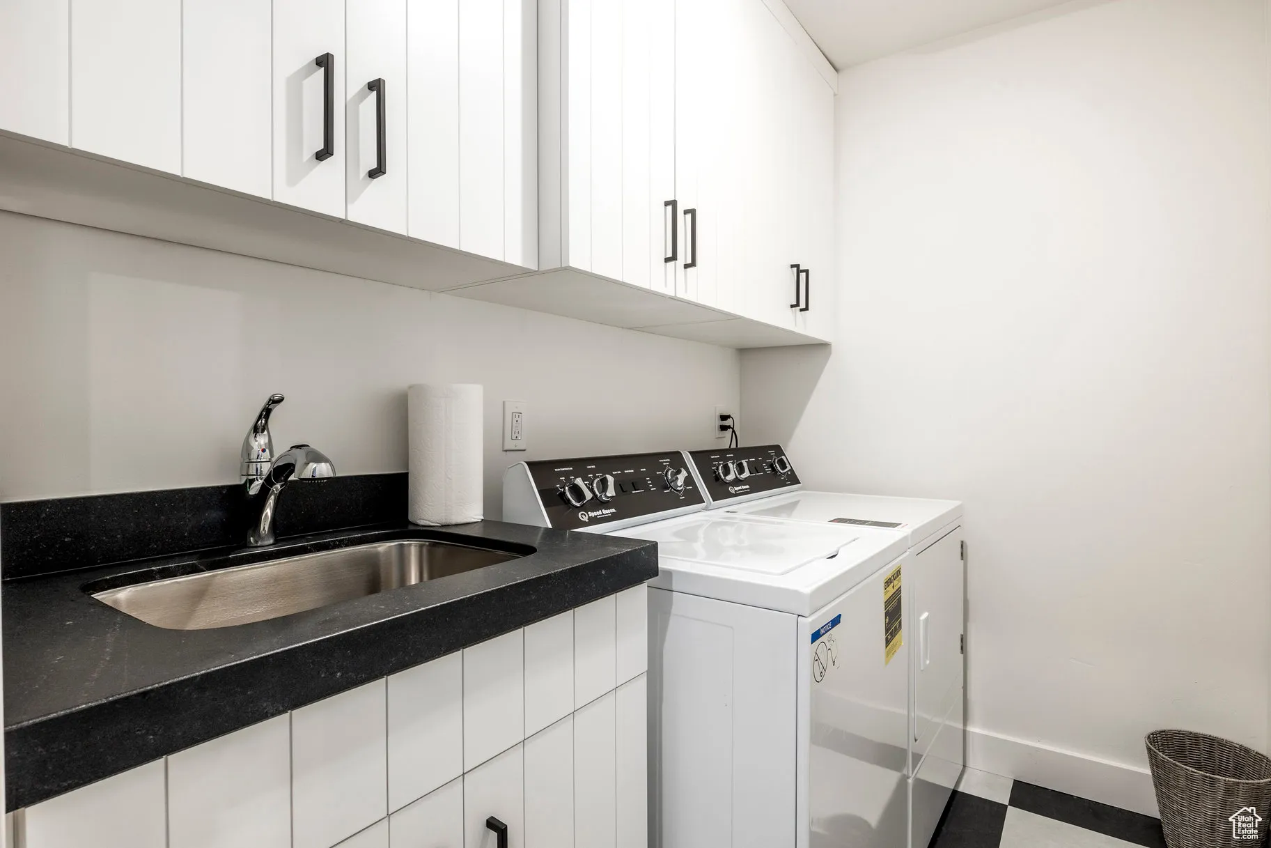 Laundry room featuring washer and clothes dryer and cabinet space