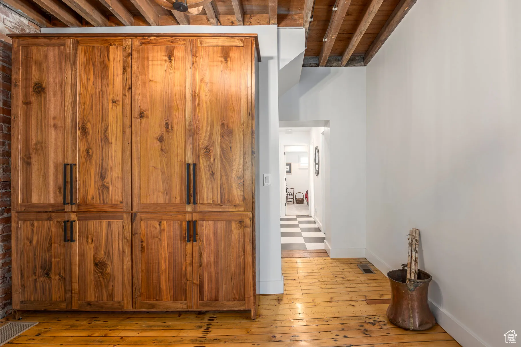Corridor featuring light wood-style flooring and baseboards