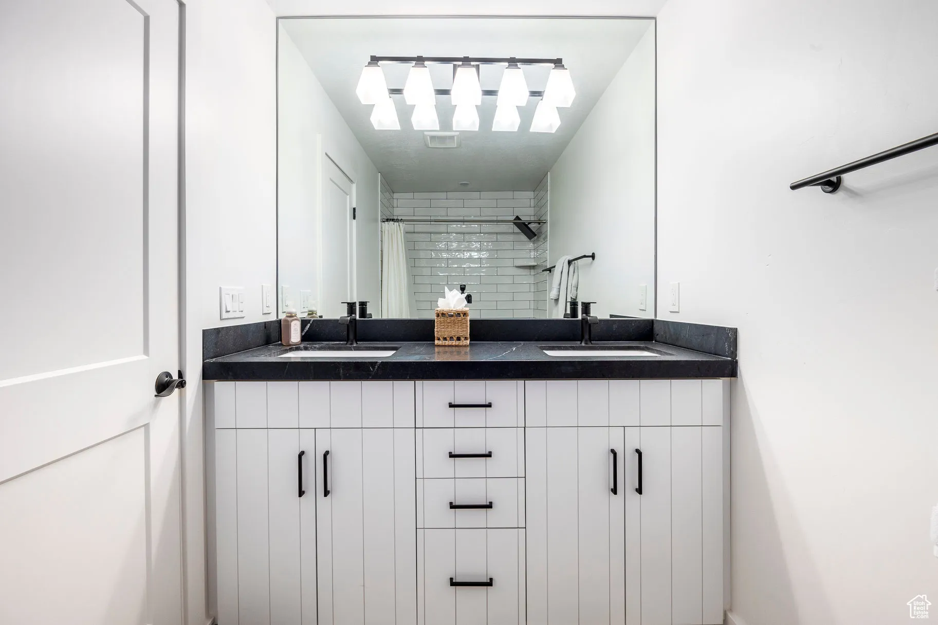 Bathroom with double vanity and a shower with shower curtain