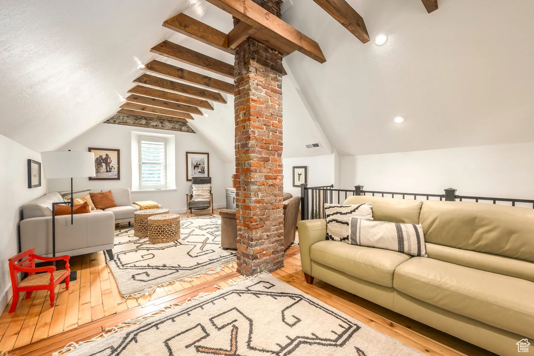 Living area with hardwood / wood-style floors and decorative columns