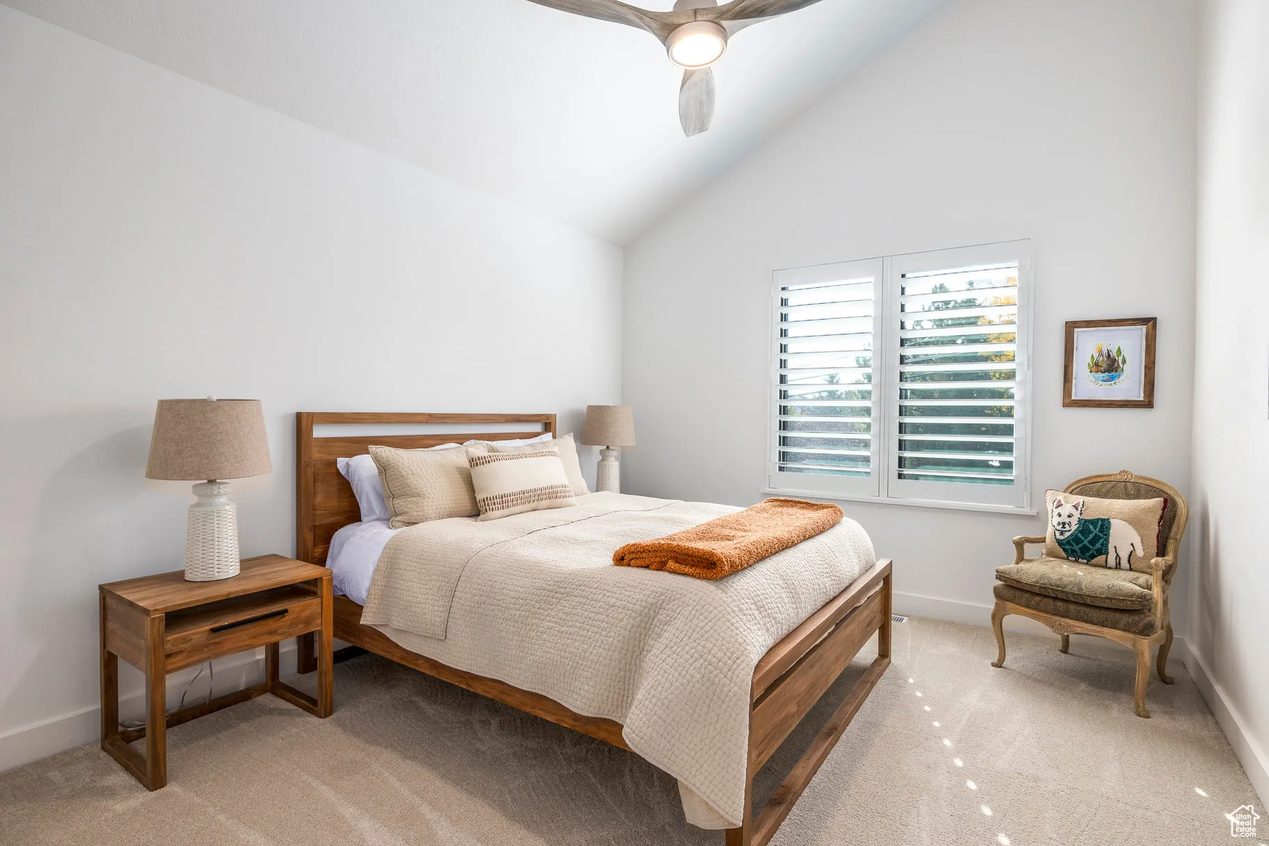 Bedroom with light carpet, vaulted ceiling, and a ceiling fan
