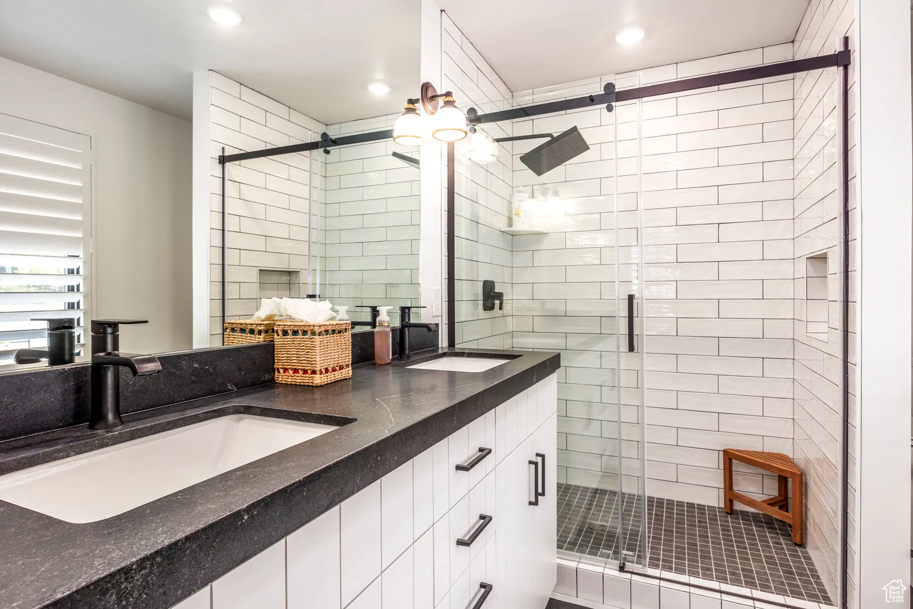 Bathroom featuring double vanity, a stall shower, and recessed lighting
