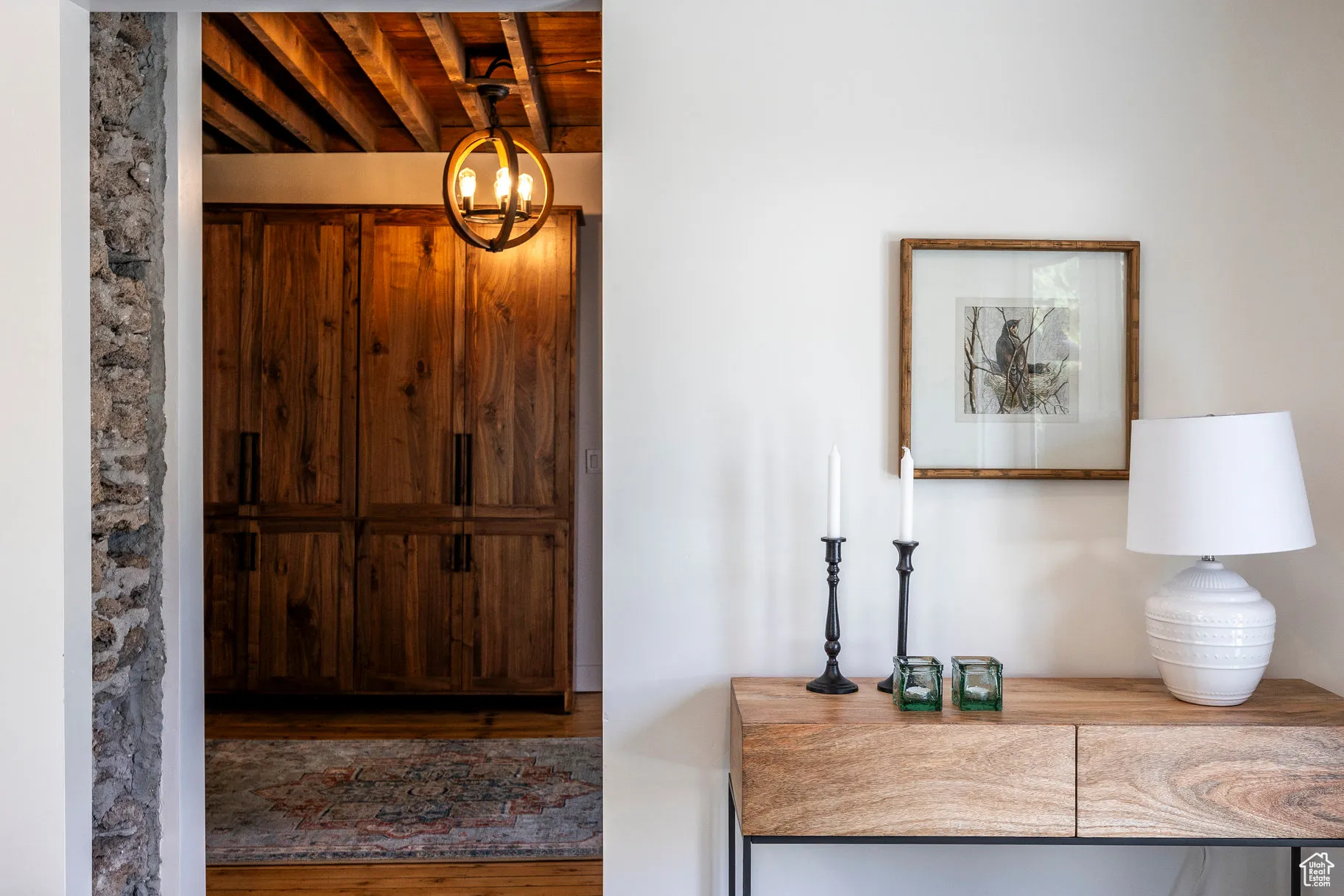 Foyer entrance featuring wood finished floors, a chandelier, and wood ceiling
