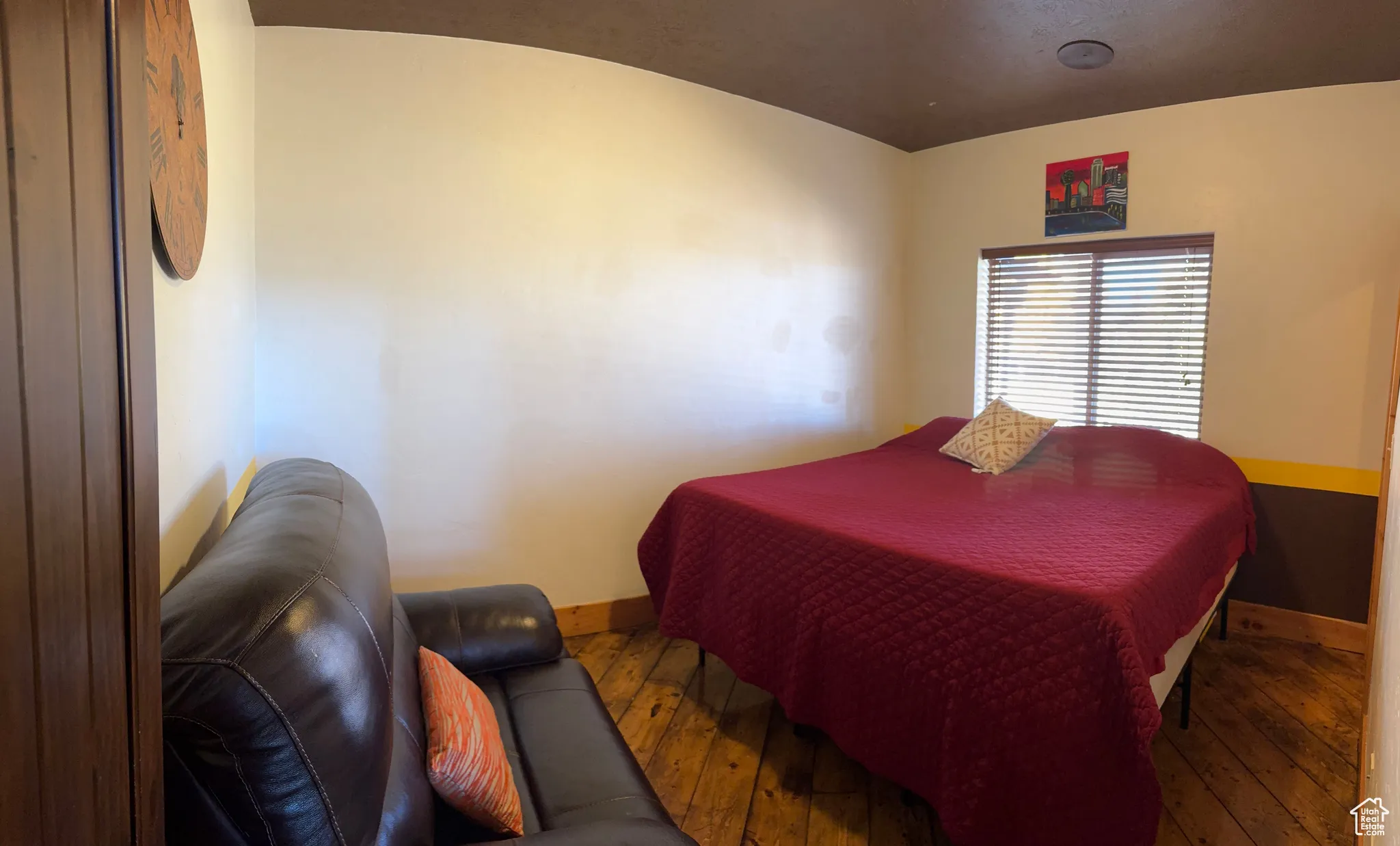 Bedroom with hardwood / wood-style floors and baseboards
