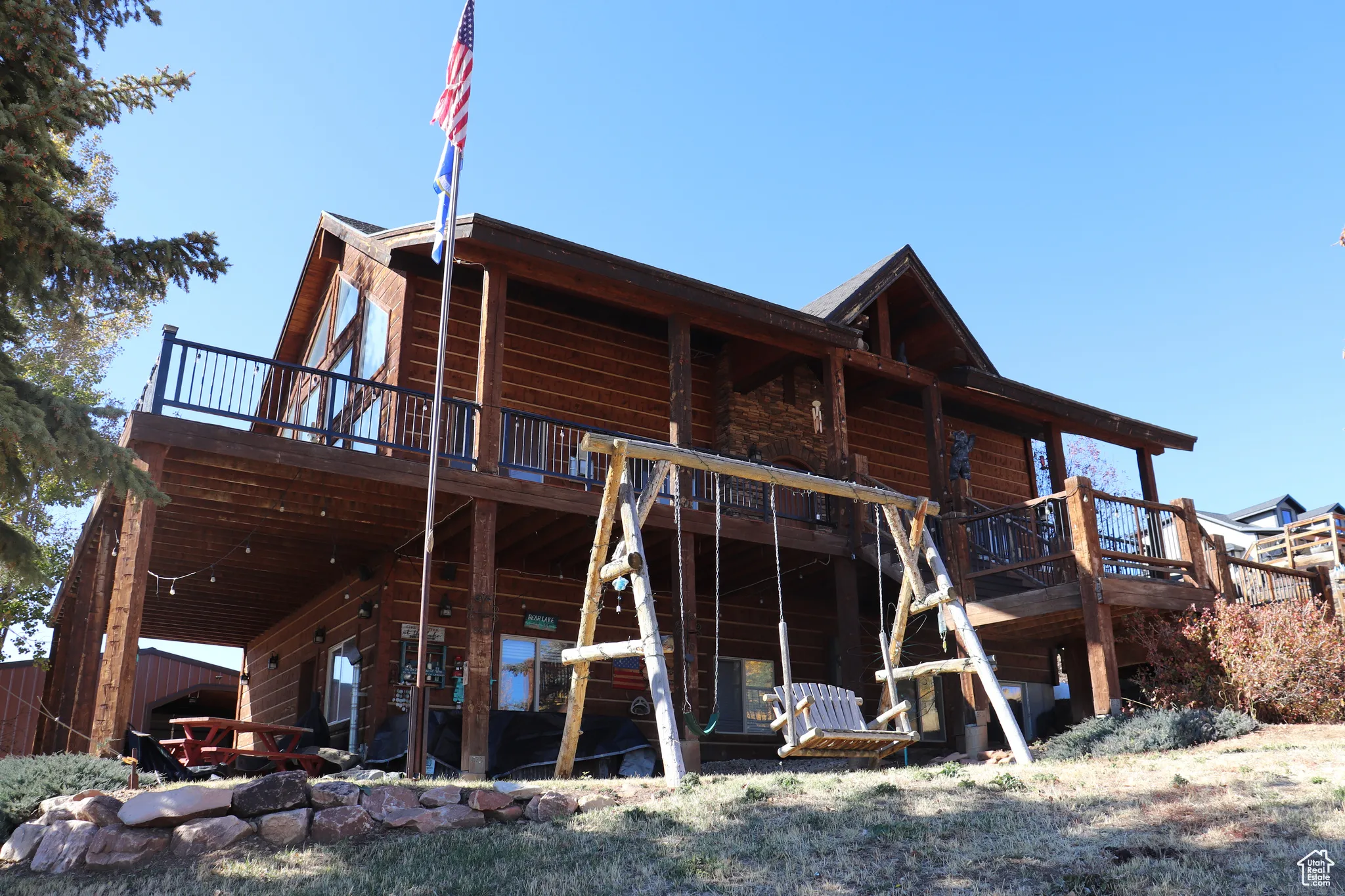 Back of property featuring a deck and a patio