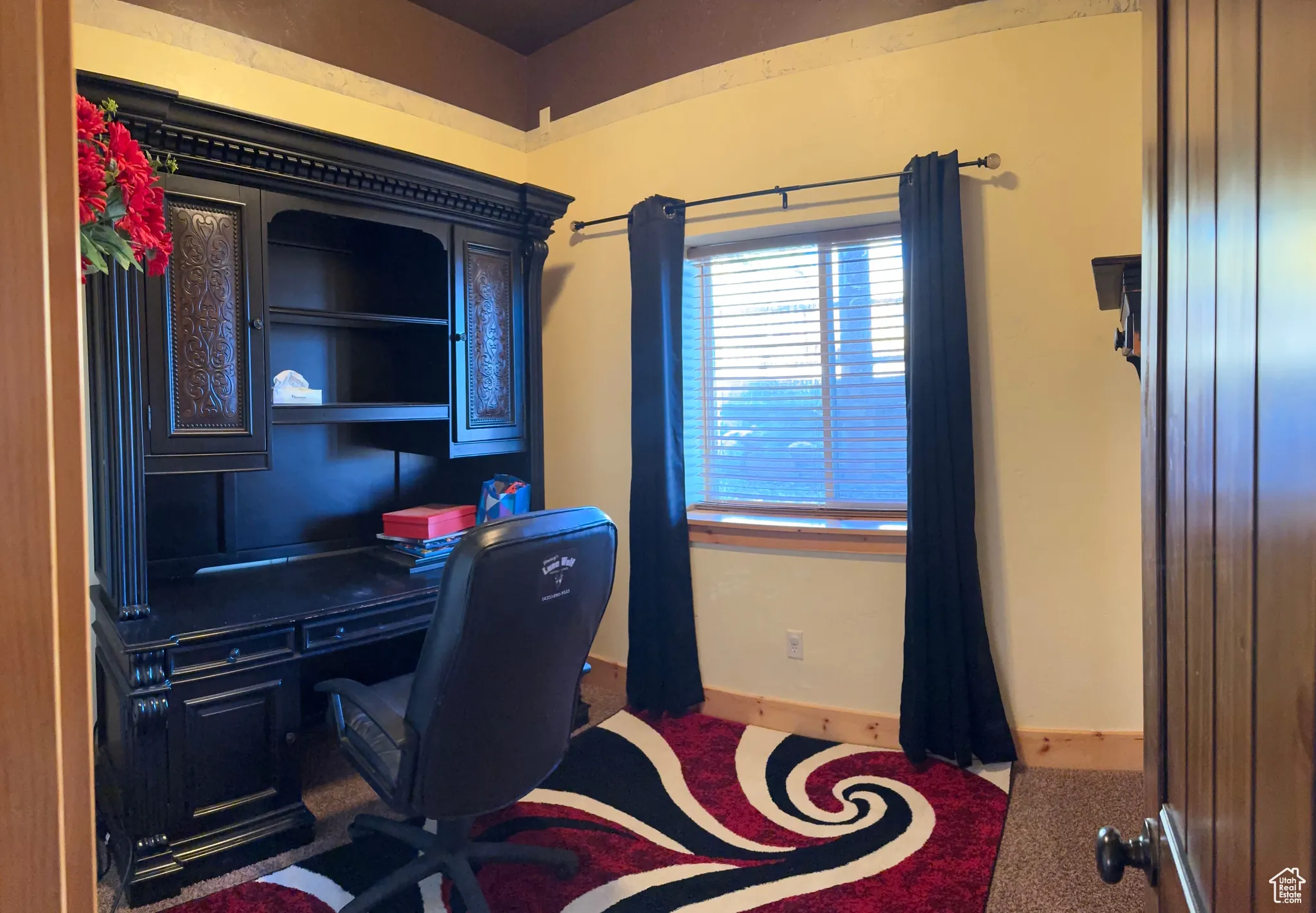 Office featuring baseboards and dark colored carpet