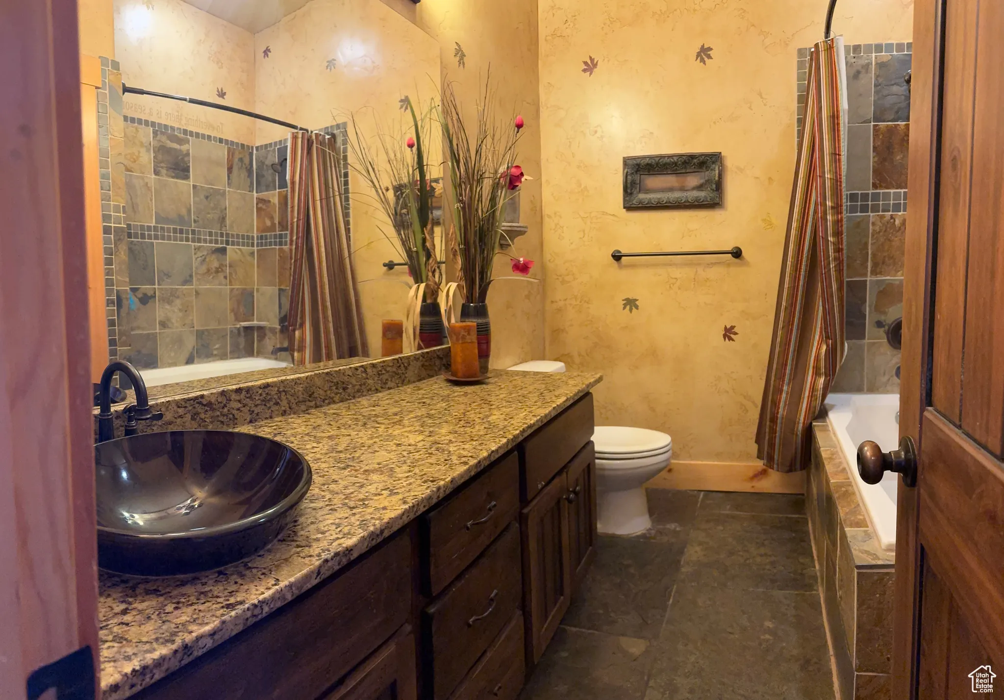 Bathroom with shower / bath combo with shower curtain and vanity