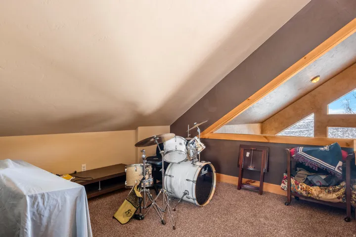 Playroom with lofted ceiling and carpet flooring