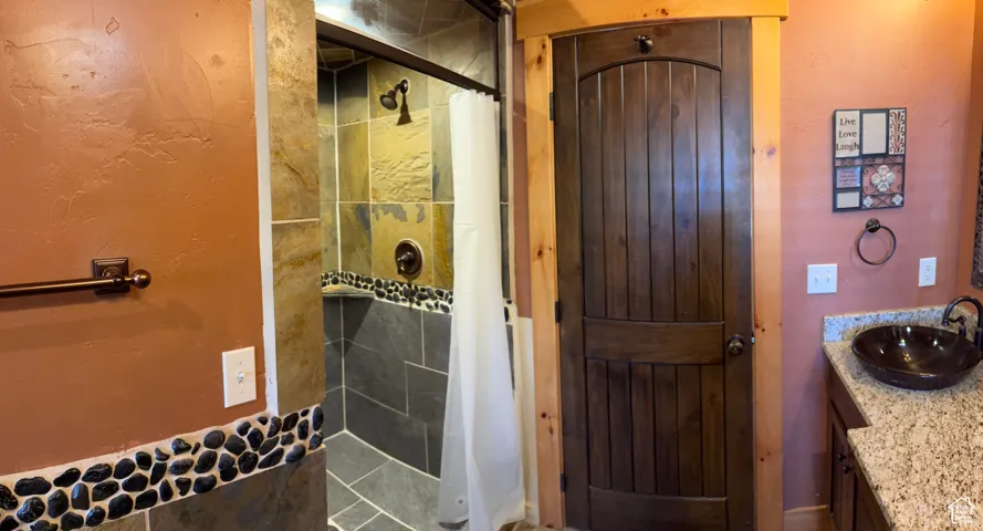 Full bathroom featuring vanity and a shower stall