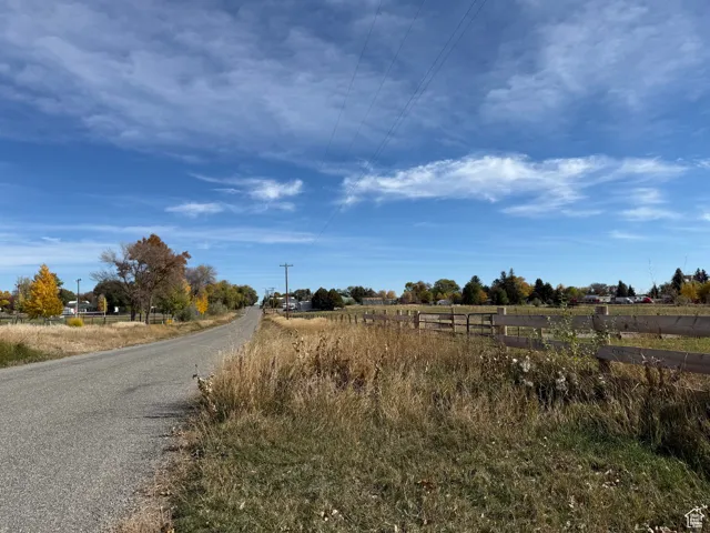View of asphalt road with a view of rural / pastoral area