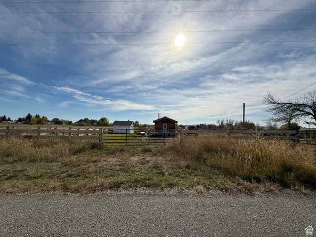 View of yard featuring a rural view and an outdoor structure