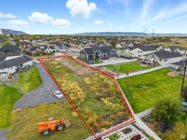 Aerial perspective of suburban area with mountains and property boundaries highlighted