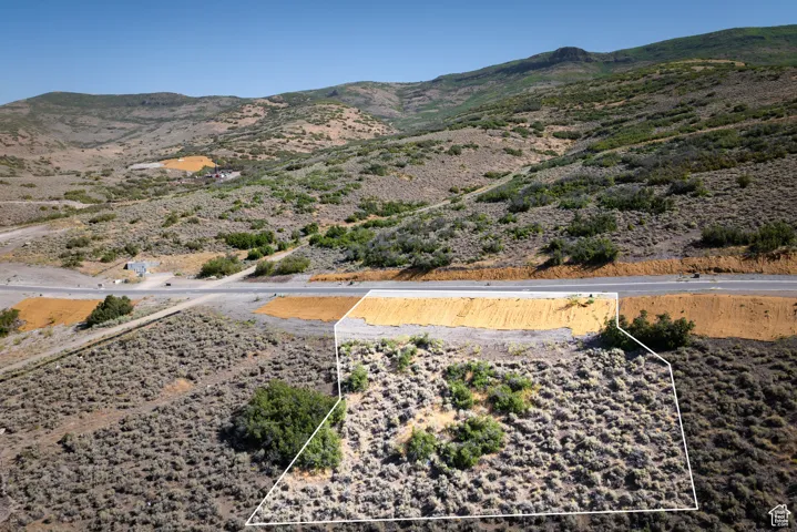 Overview of rural landscape featuring a mountainous background and property parcel outlined