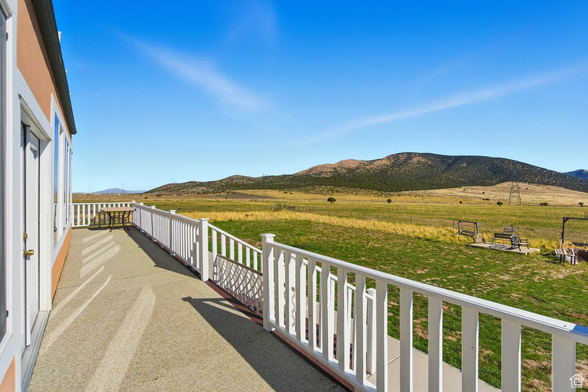 Deck with a mountain view and a view of countryside.