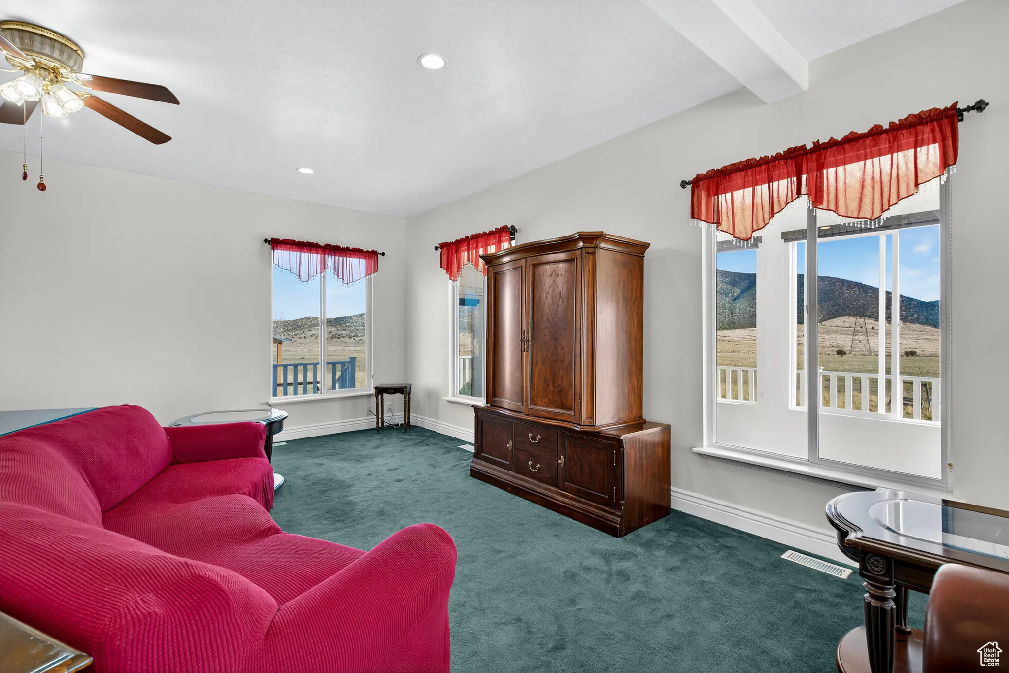 Living room with carpet, beamed ceiling, recessed lighting, a mountain view, and ceiling fan.