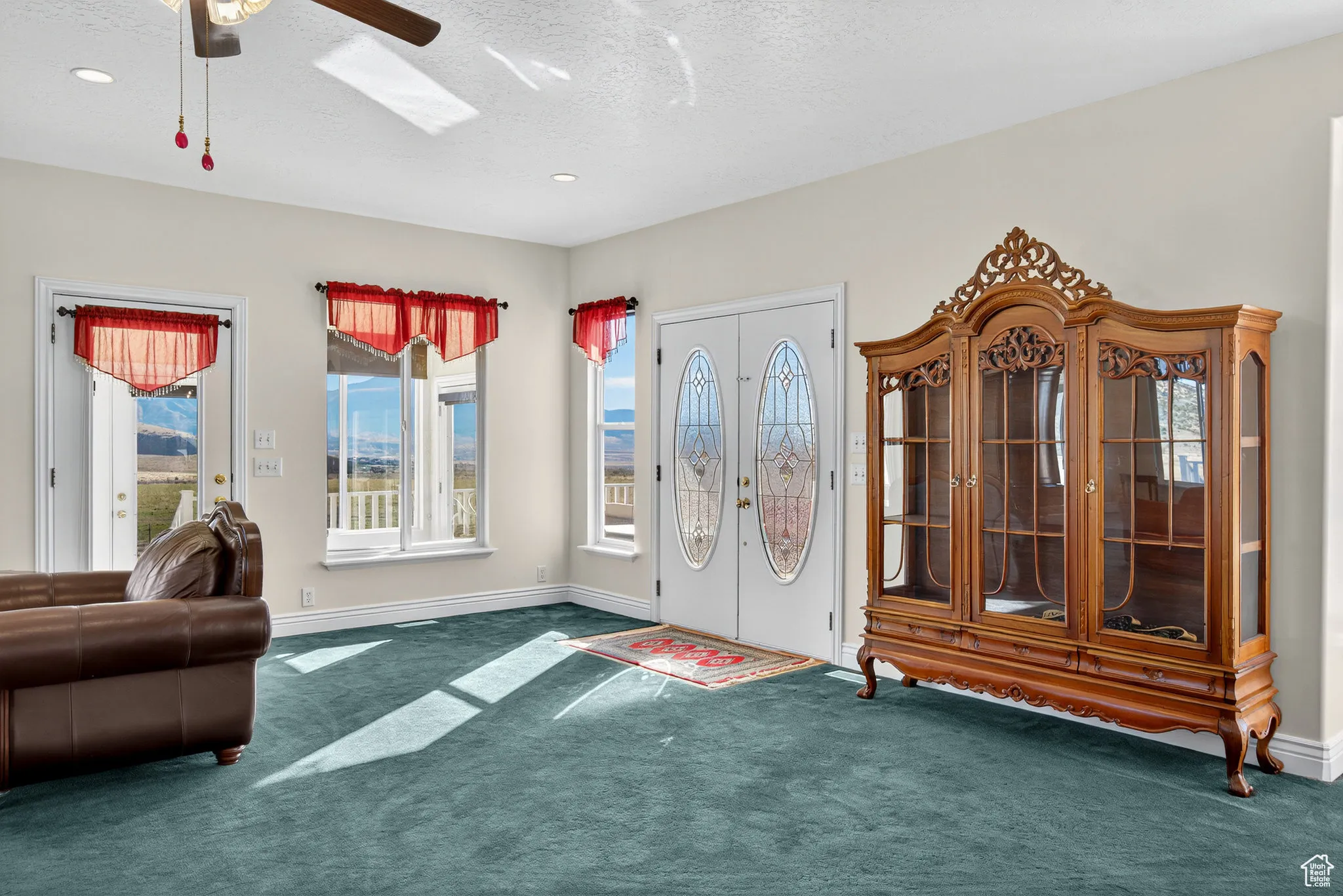French doors to porch seating area, carpet flooring, a ceiling fan, and recessed lighting.