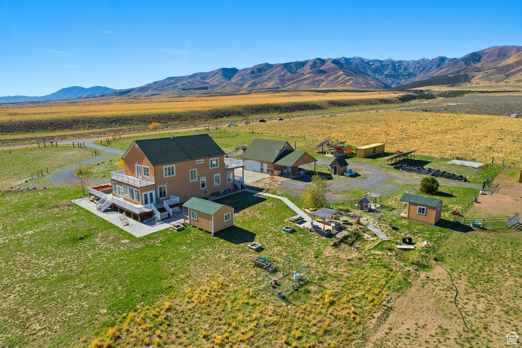 Overview of home and landscape with a mountainous background.