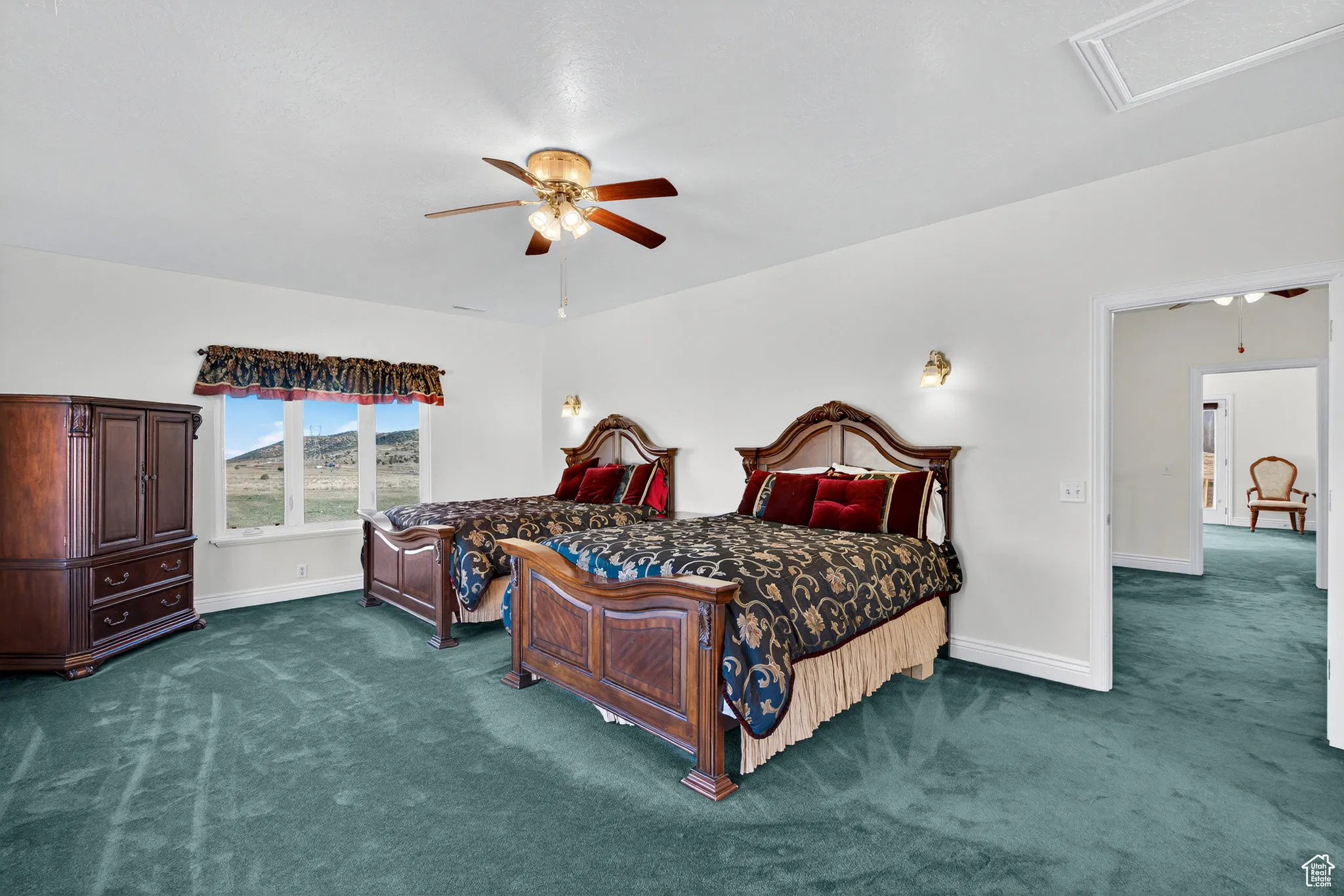 Large second floor West bedroom featuring carpet and ceiling fan.