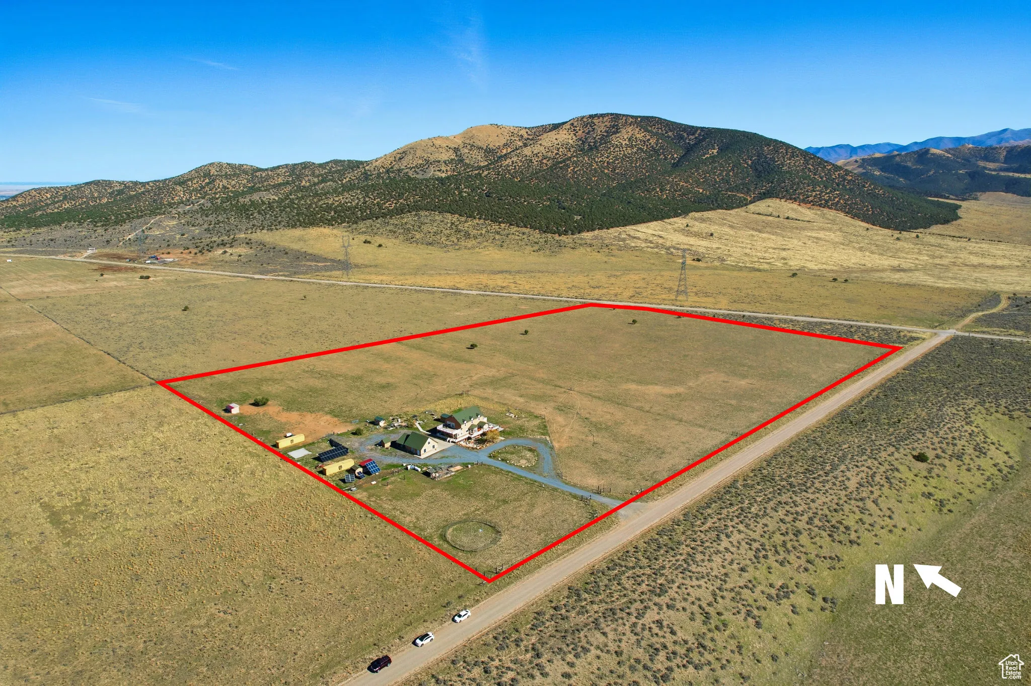 Overview of property with a mountain backdrop and property boundaries highlighted, north east.