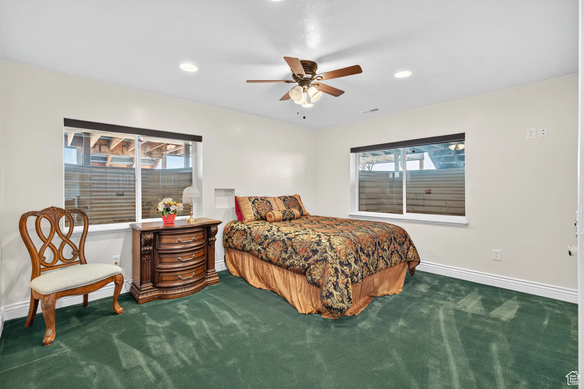 Basement bedroom with ceiling fan and recessed lighting.
