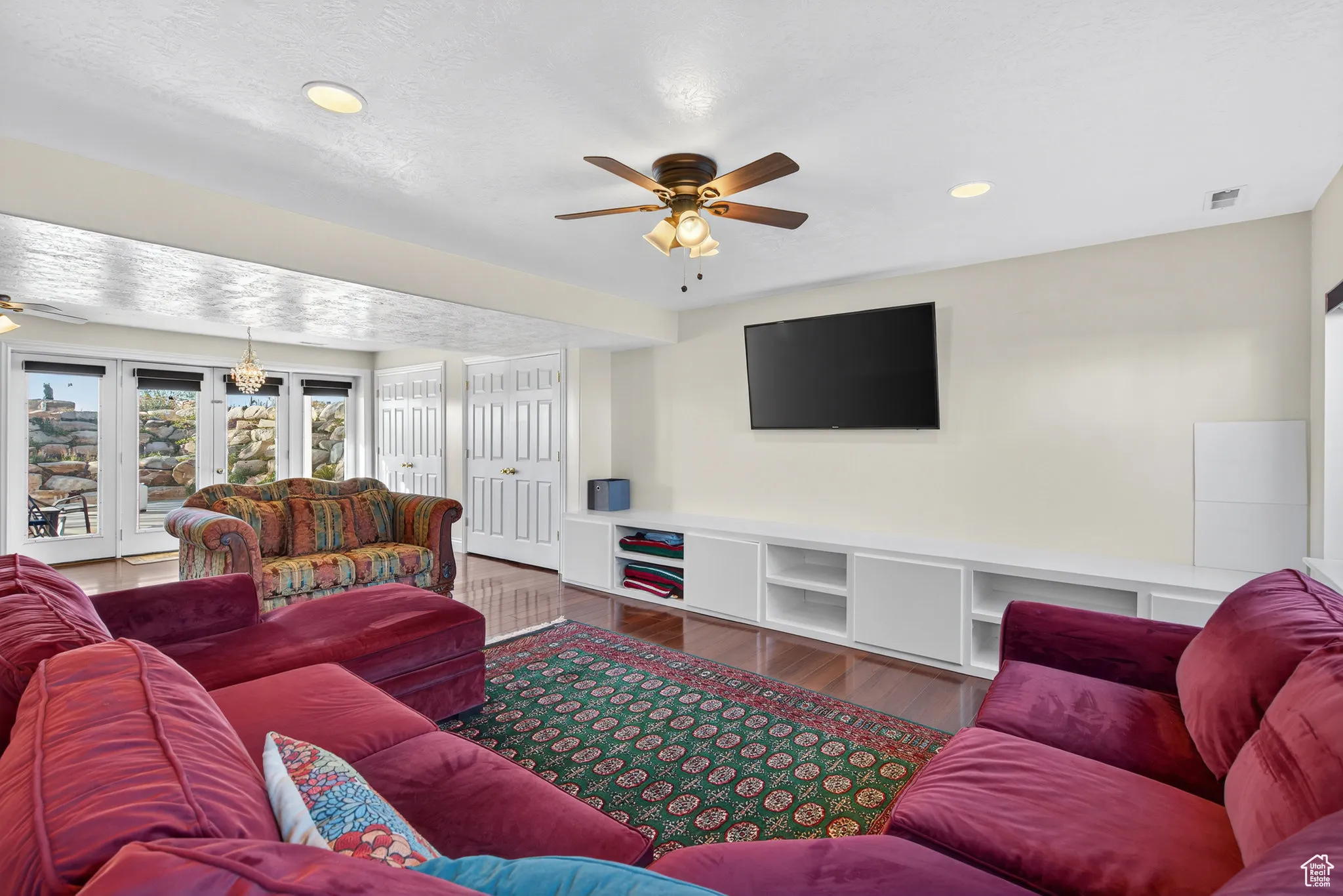 Basement living room featuring a ceiling fan, wood style floors, recessed lighting.